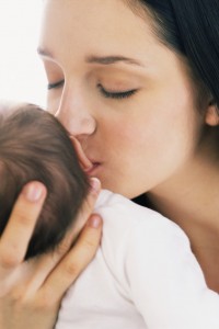 Young Mother Kissing Infant